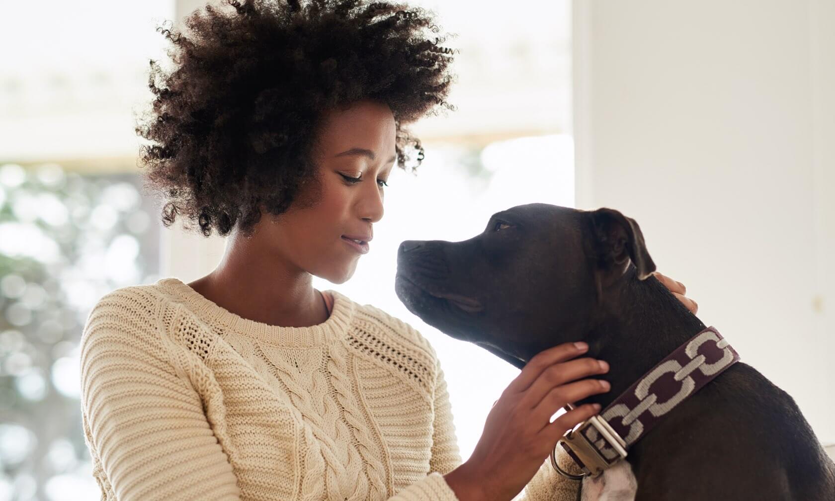 Woman petting her dog.