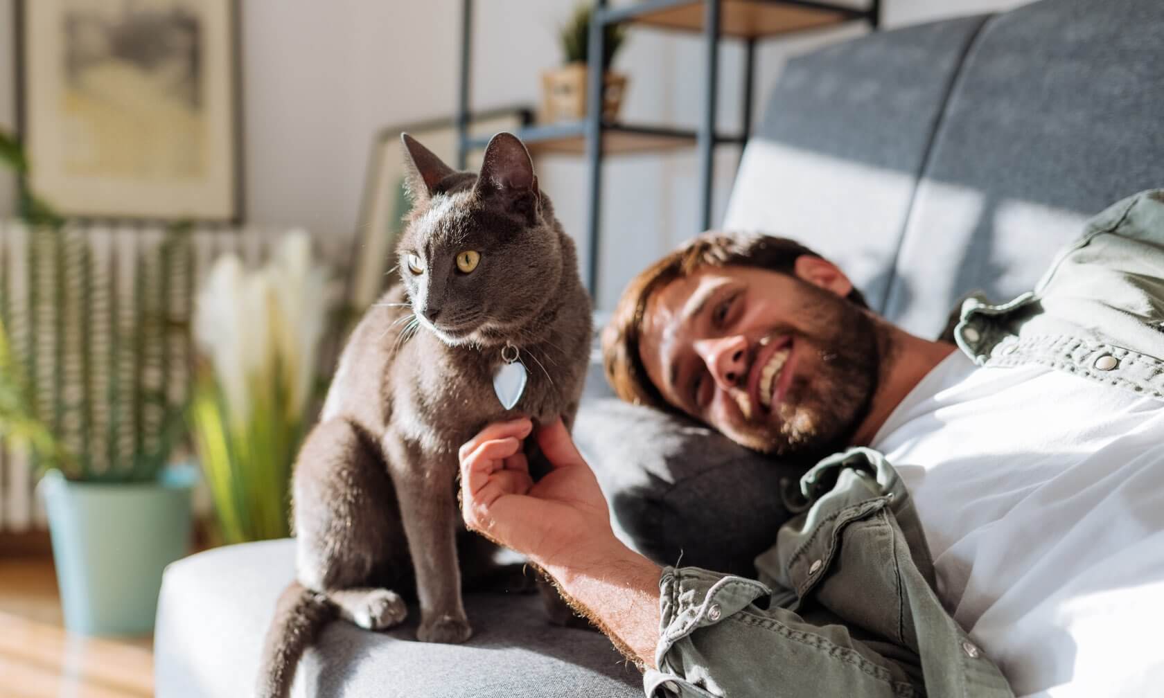 Man petting his cat.