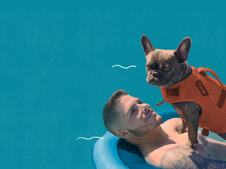 man in pool with dog