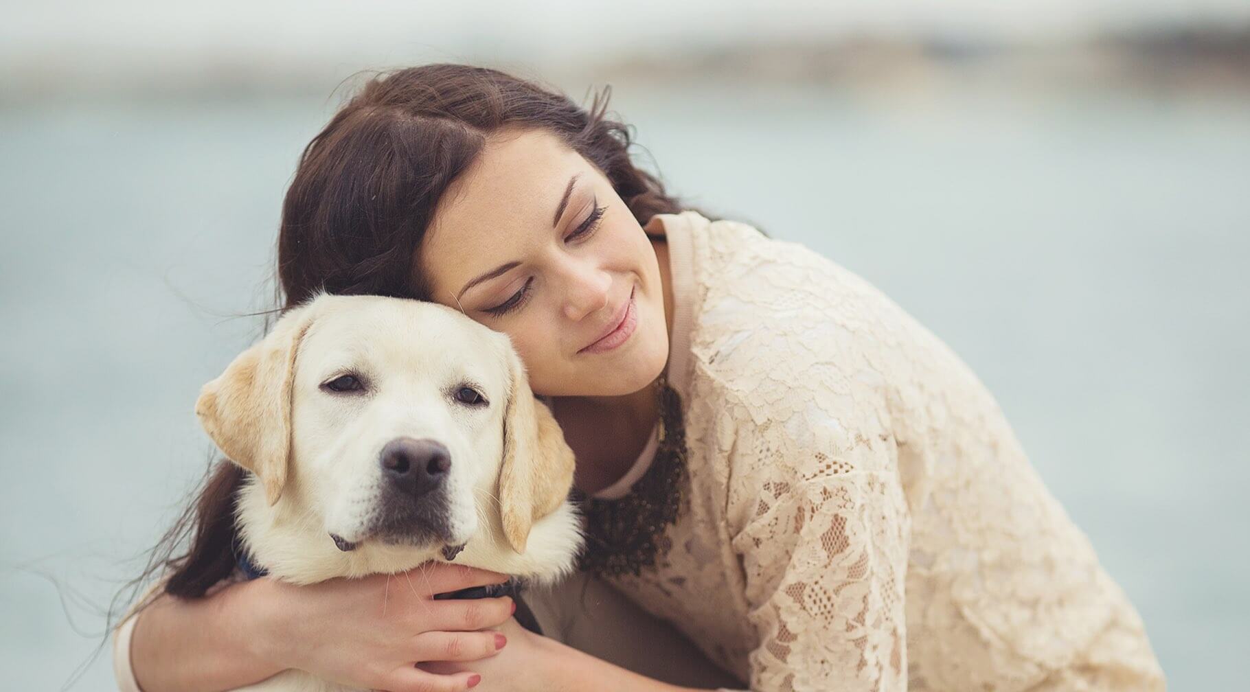 Woman hugging dog.